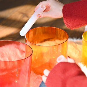 Orange and red rainbow singing bowls closeup