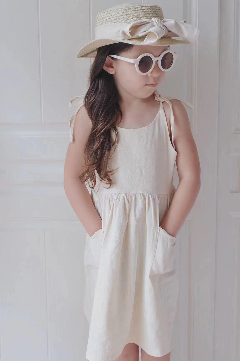 Girl standing with hands in pocket in our sweet and breezy linen dress | Surfersandyogis