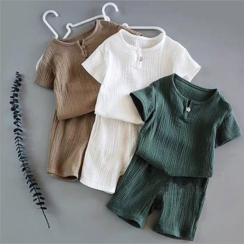 Boho neutral baby clothes in green beige blue and white. Cute boho retro baby clothes. Perfect for the surfer baby at the beach