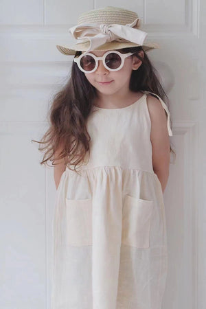 Girl looking bashful in our white sweet and breezy linen summer dress | Surfersandyogis