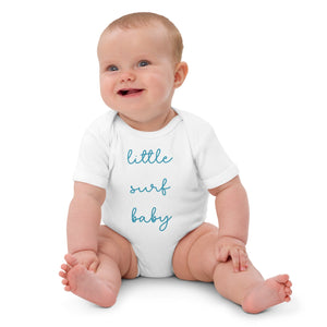 Baby smiling in little surf baby white bodysuit